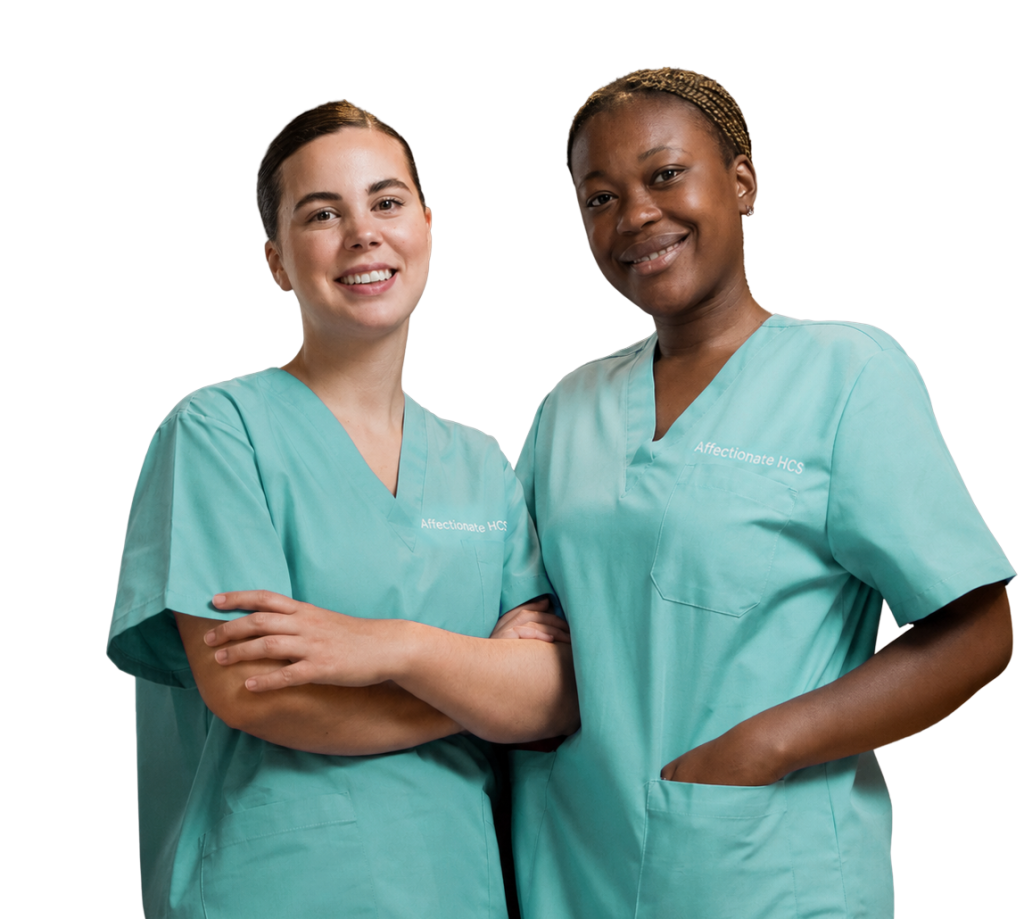 Two smiling healthcare professionals in scrubs.