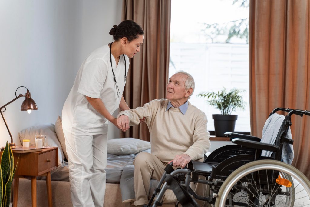 Nurse assisting elderly man in wheelchair